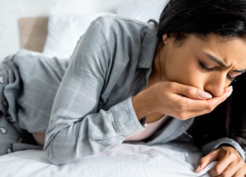 Young woman experiencing nausea