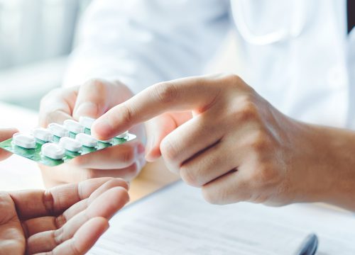 Doctor handing a patient medicine
