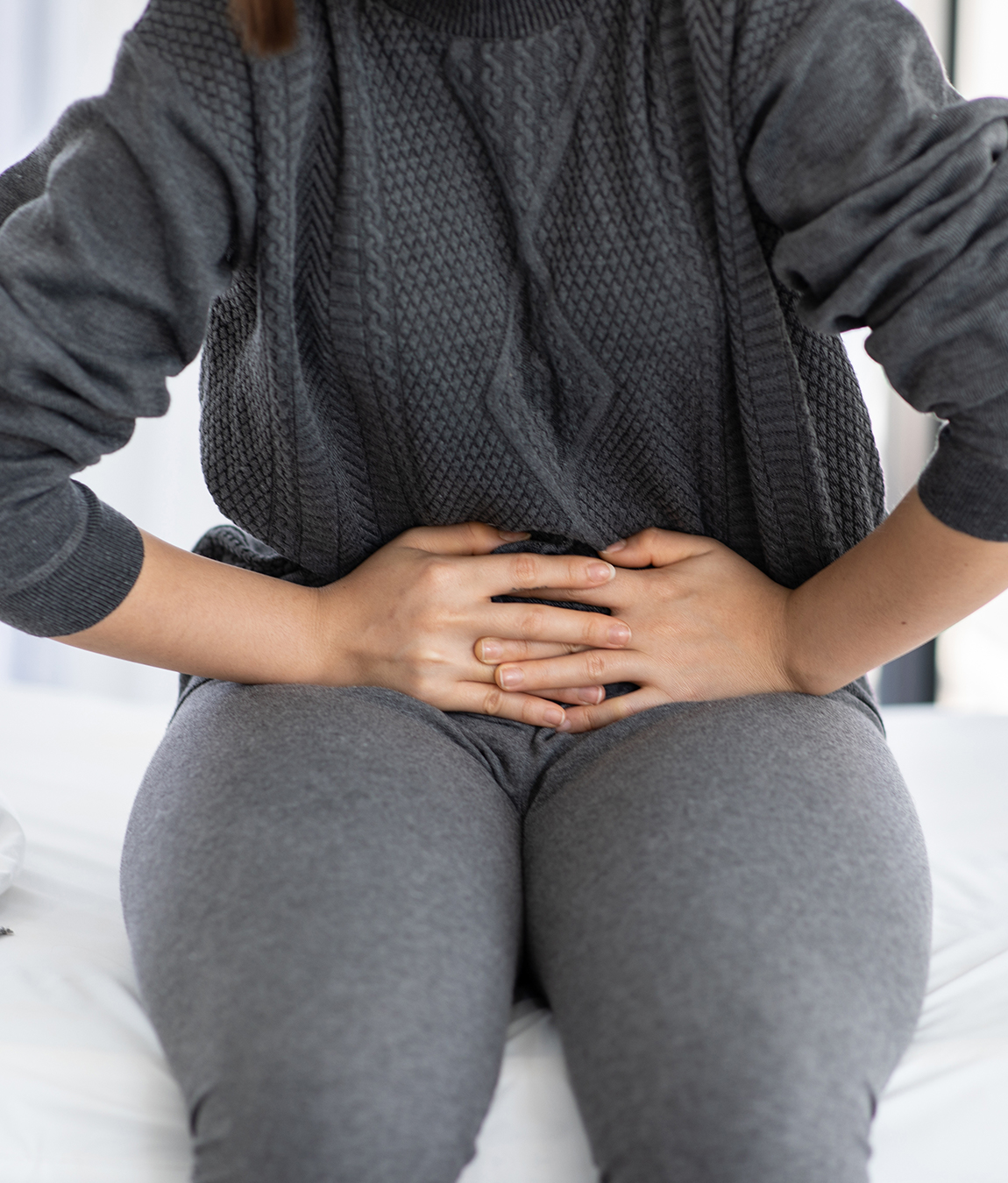 Woman clutching her bladder area